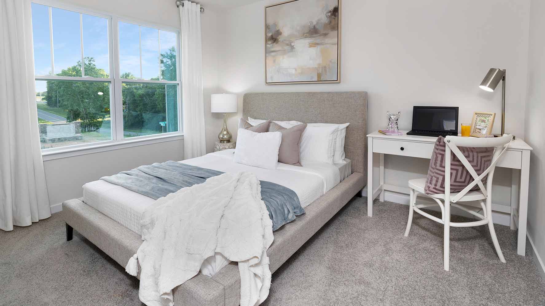 Carpeted bedroom with large window