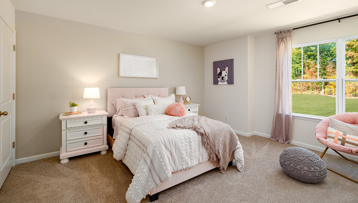 Carpeted bedroom with large windows