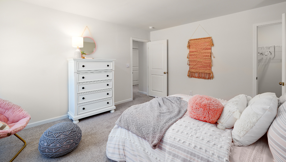 Carpeted bedroom with large windows