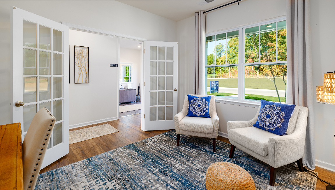 Carpeted bedroom with large windows