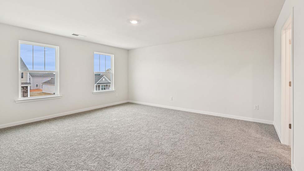 Carpeted bedroom with large windows