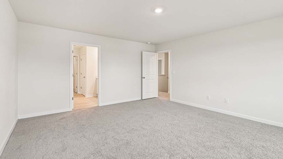 Carpeted bedroom with large windows