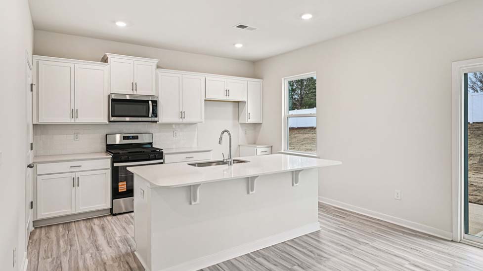 Kitchen and island with stainless steel appliances