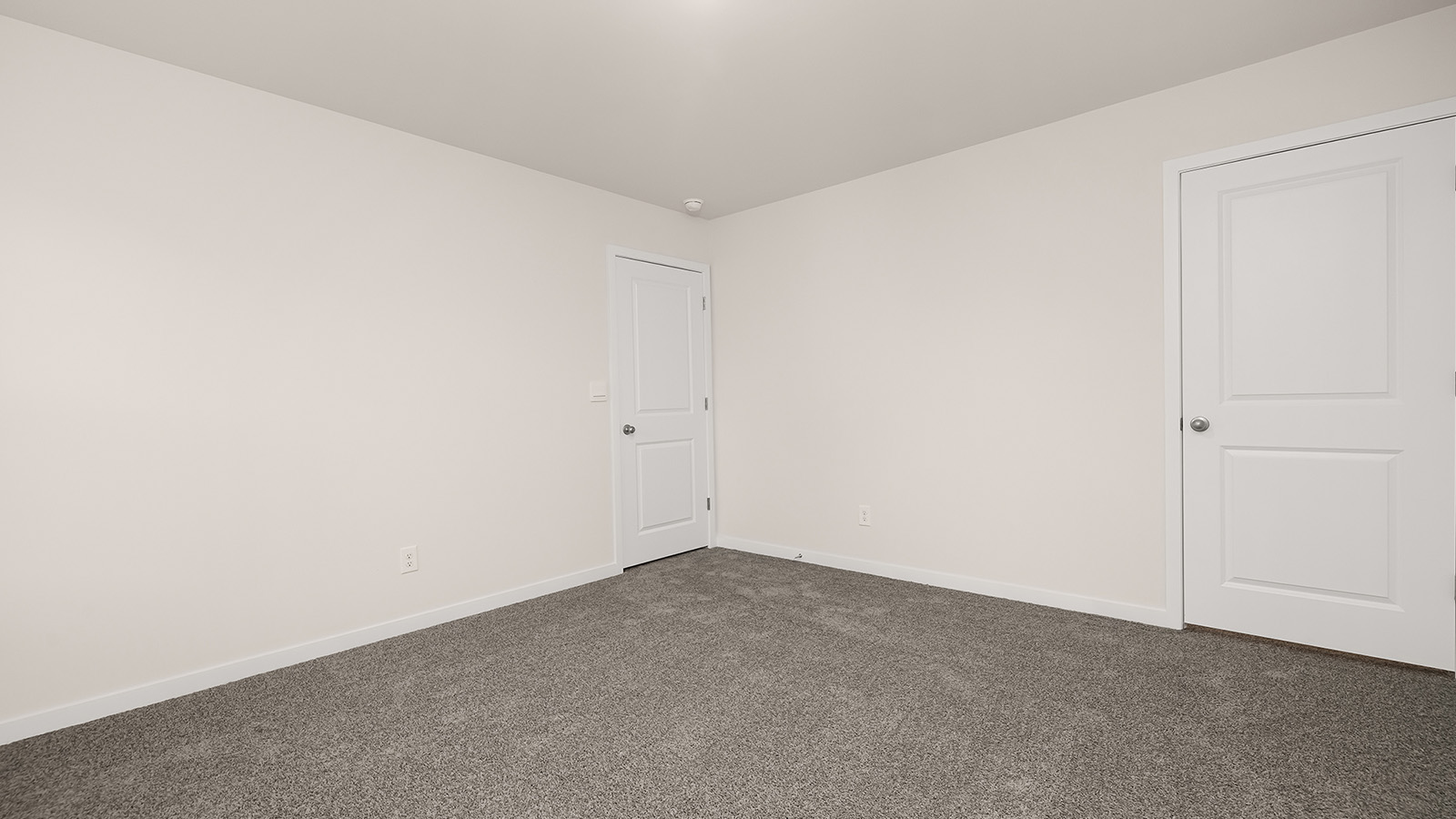 Carpeted bedroom with large windows