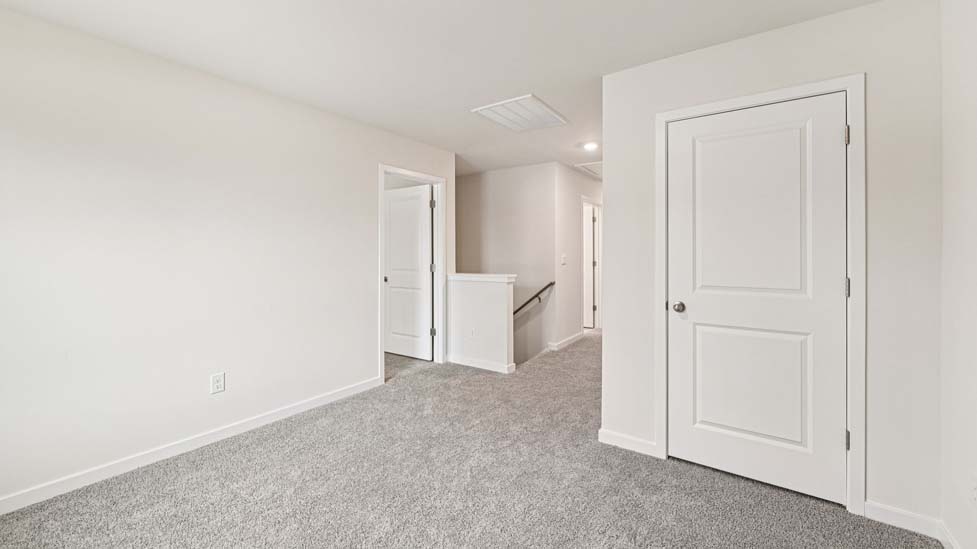 Carpeted bedroom with large windows