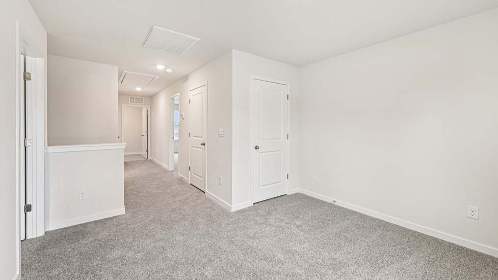 Carpeted bedroom with large windows