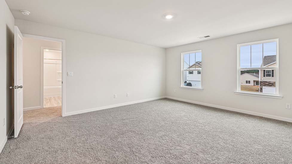 Carpeted bedroom with large windows