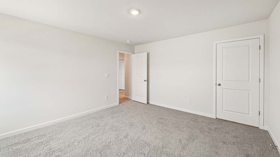 Carpeted bedroom with large windows