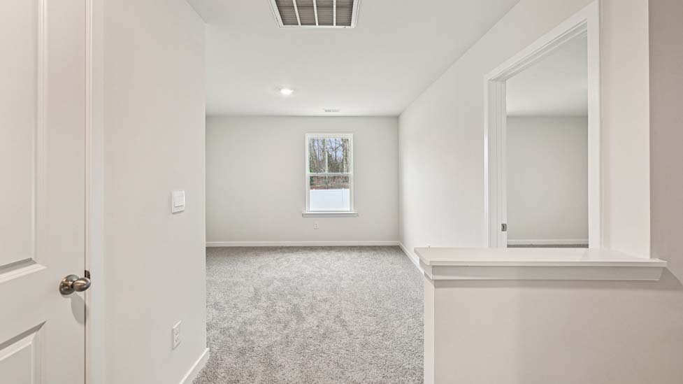 Carpeted bedroom with large window