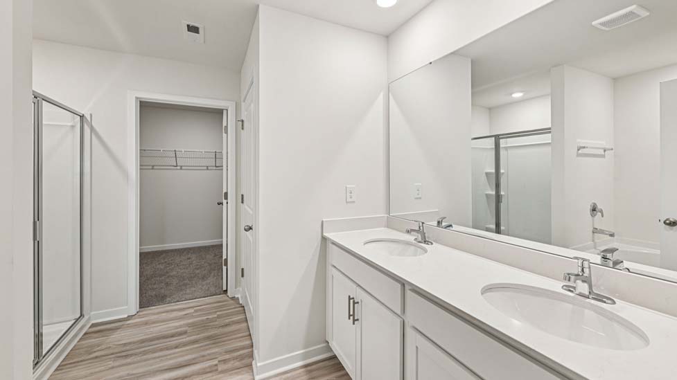 Bathroom with double sink vanity and walk in shower