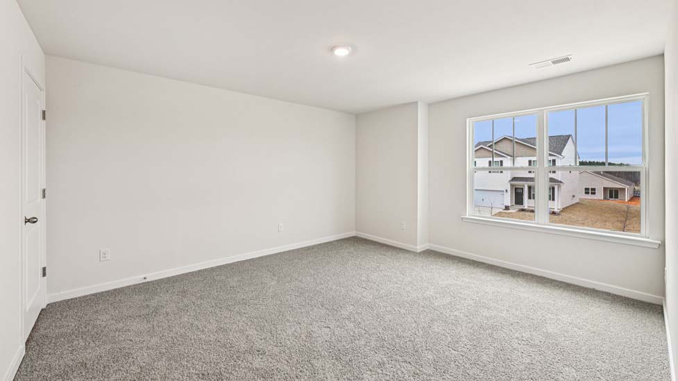 Carpeted bedroom with large window