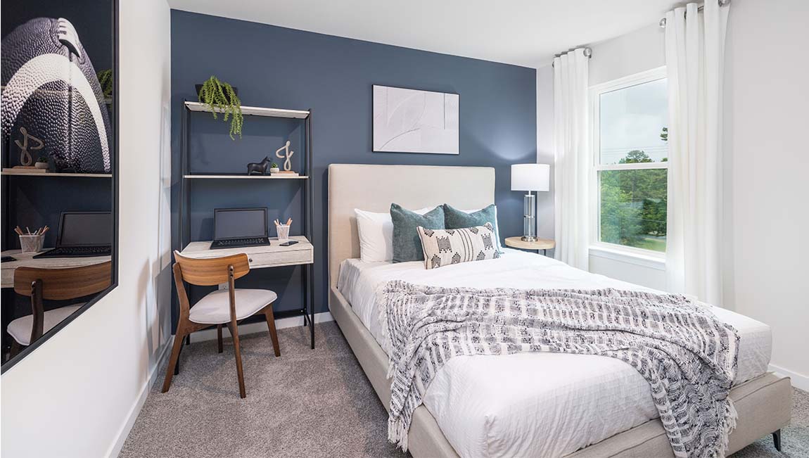 Carpeted bedroom with windows