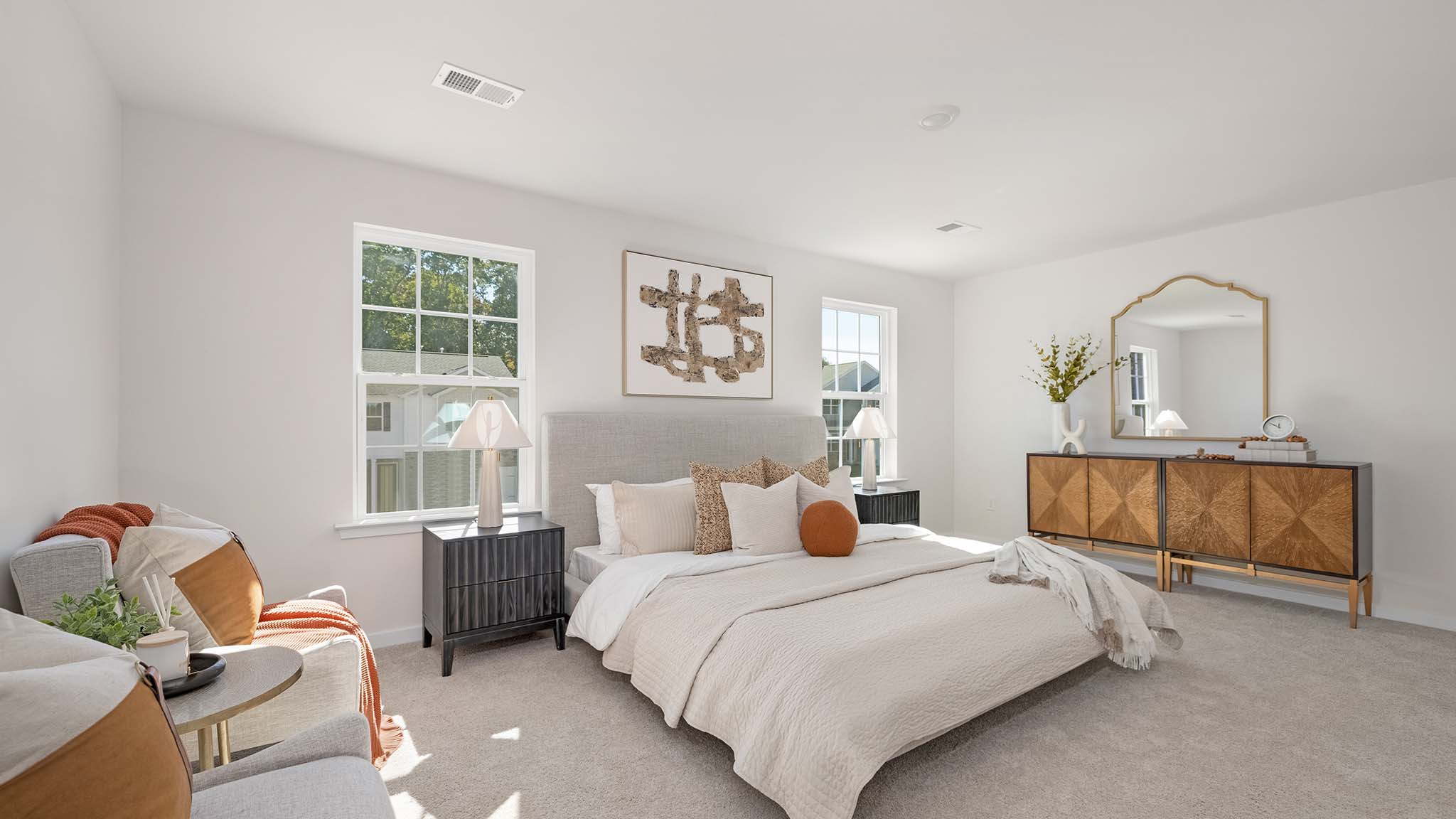 Primary carpeted bedroom with windows