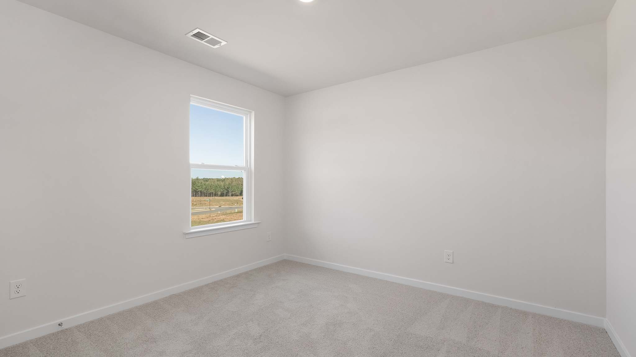 Carpeted bedroom with window