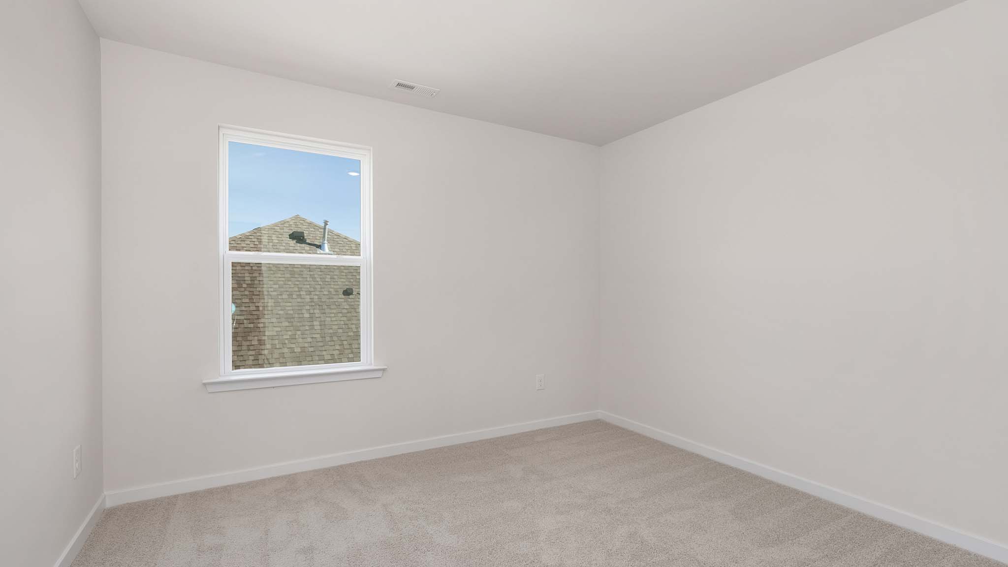 Carpeted bedroom with window