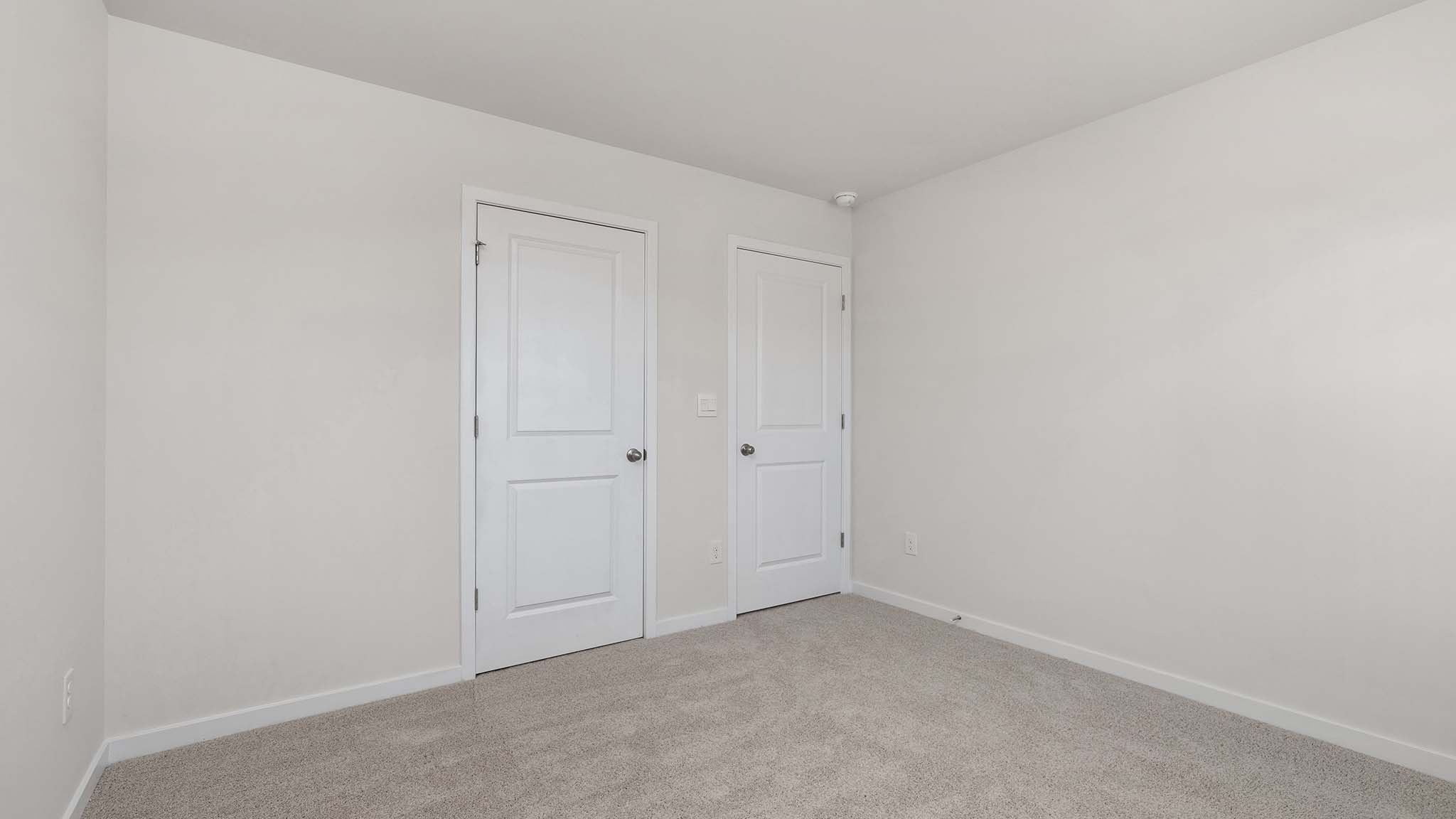 Carpeted bedroom with window