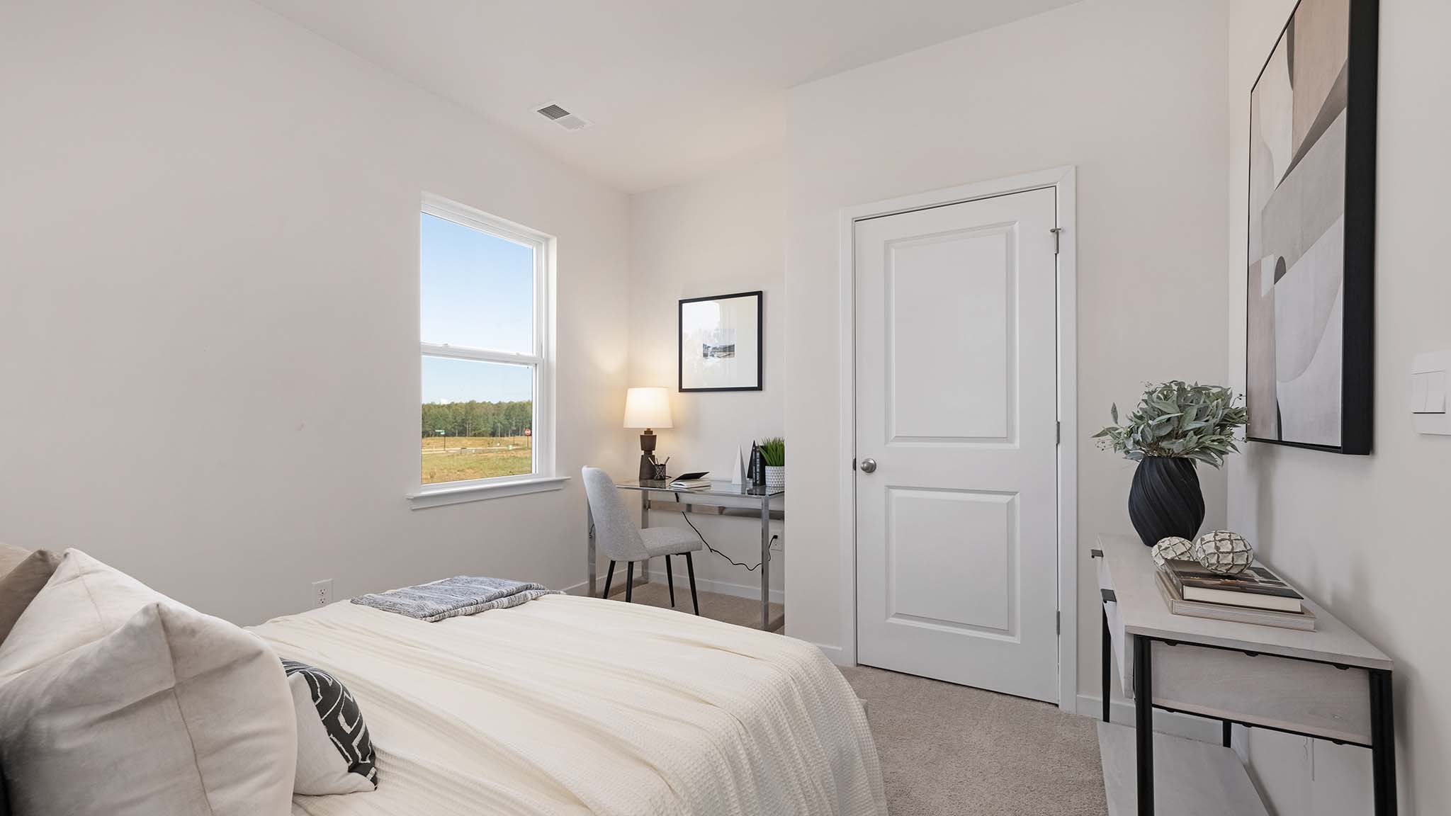 Carpeted bedroom with windows