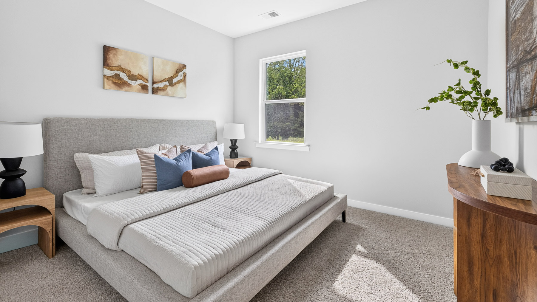 Carpeted bedroom with large window, view of bathroom door