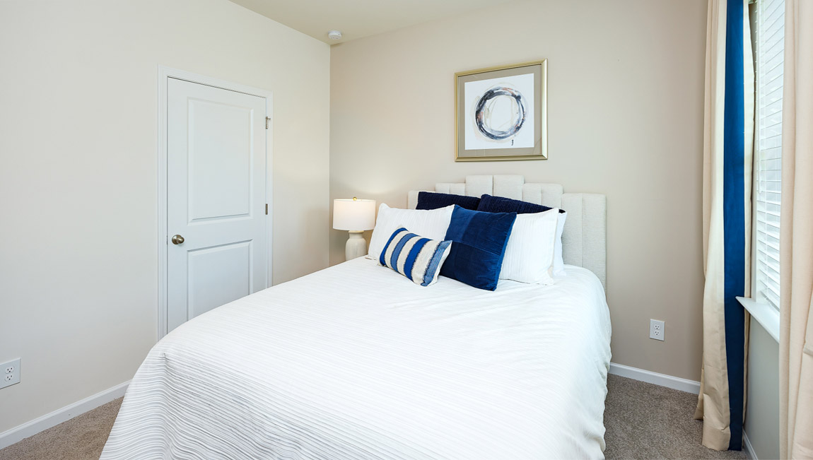 Carpeted bedroom with windows