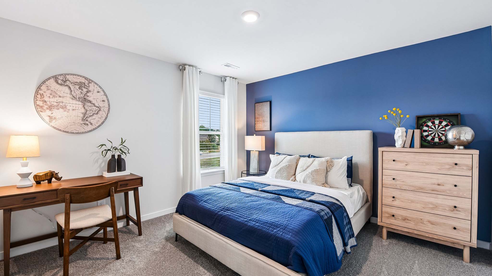 Carpeted bedroom with large window, view of bathroom door