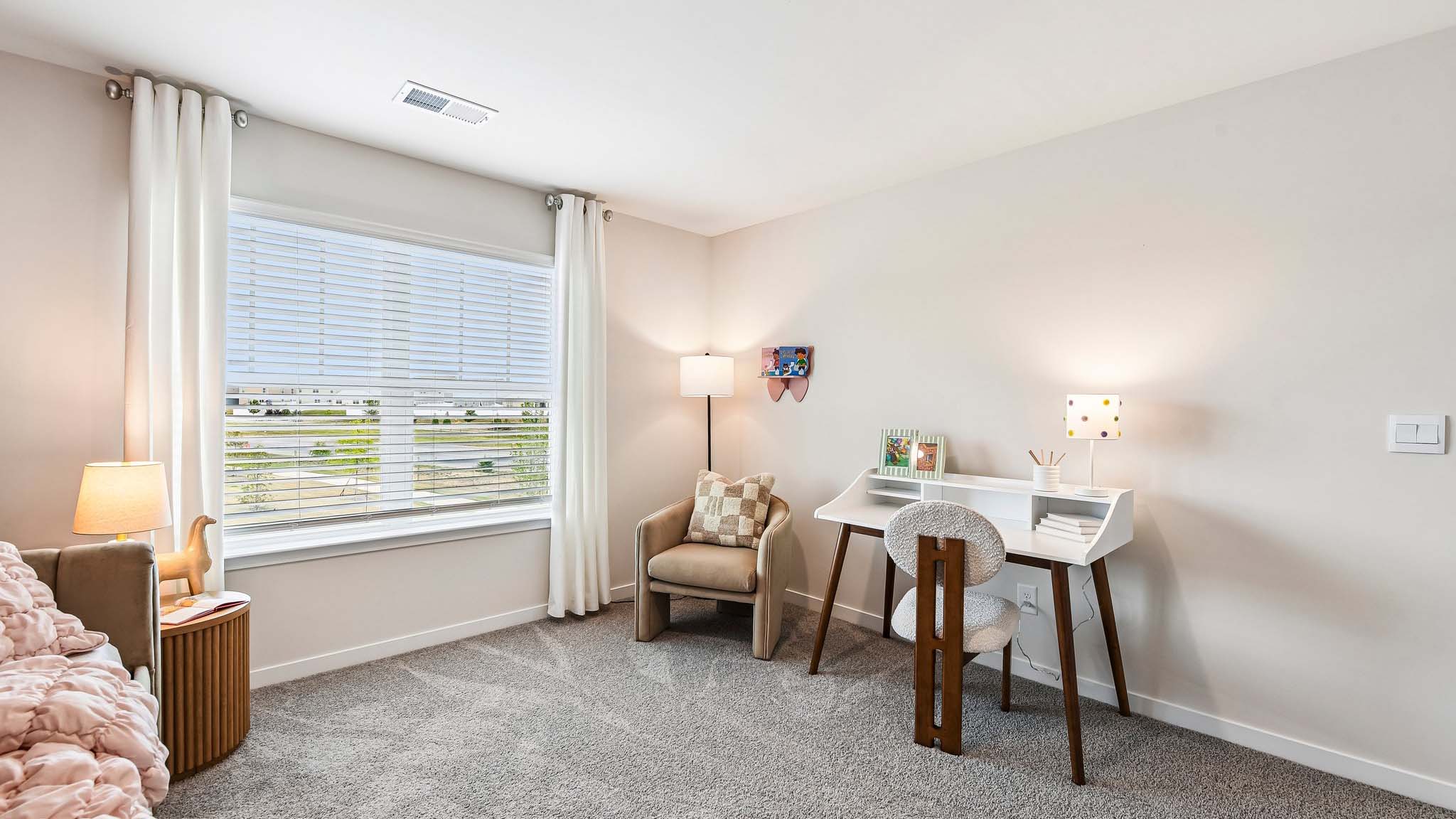 Carpeted bedroom with large window, view of bathroom door