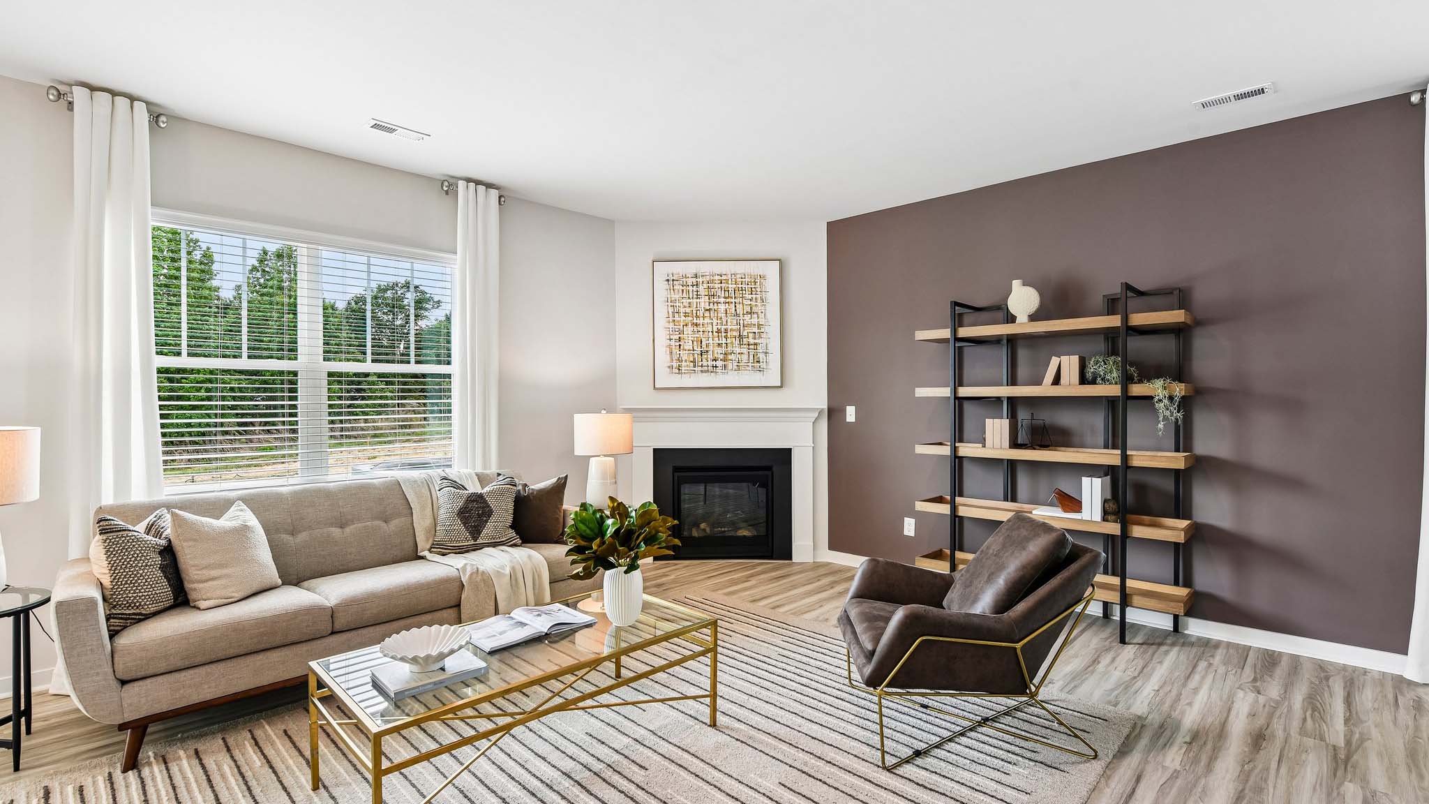 Living room space with wood floors, three large windows