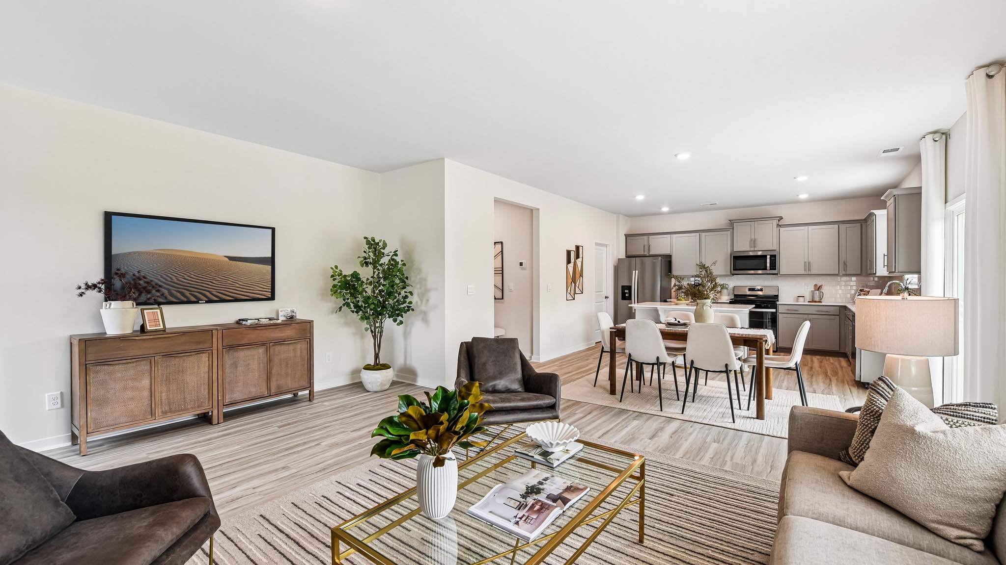 Living room space with wood floors, three large windows