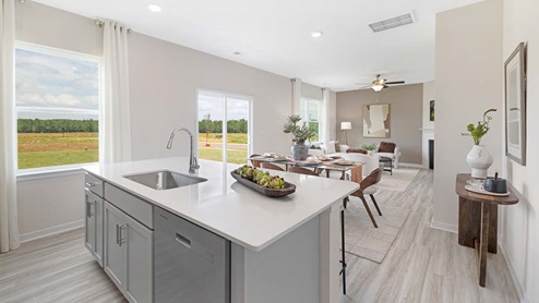 kitchen and island with seating, and stainless steel appliances