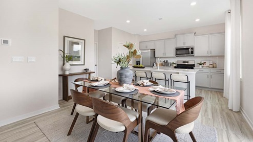 breakfast or dining area beside kitchen and living room with sliding glass back door