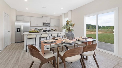 breakfast or dining area beside kitchen and living room with sliding glass back door