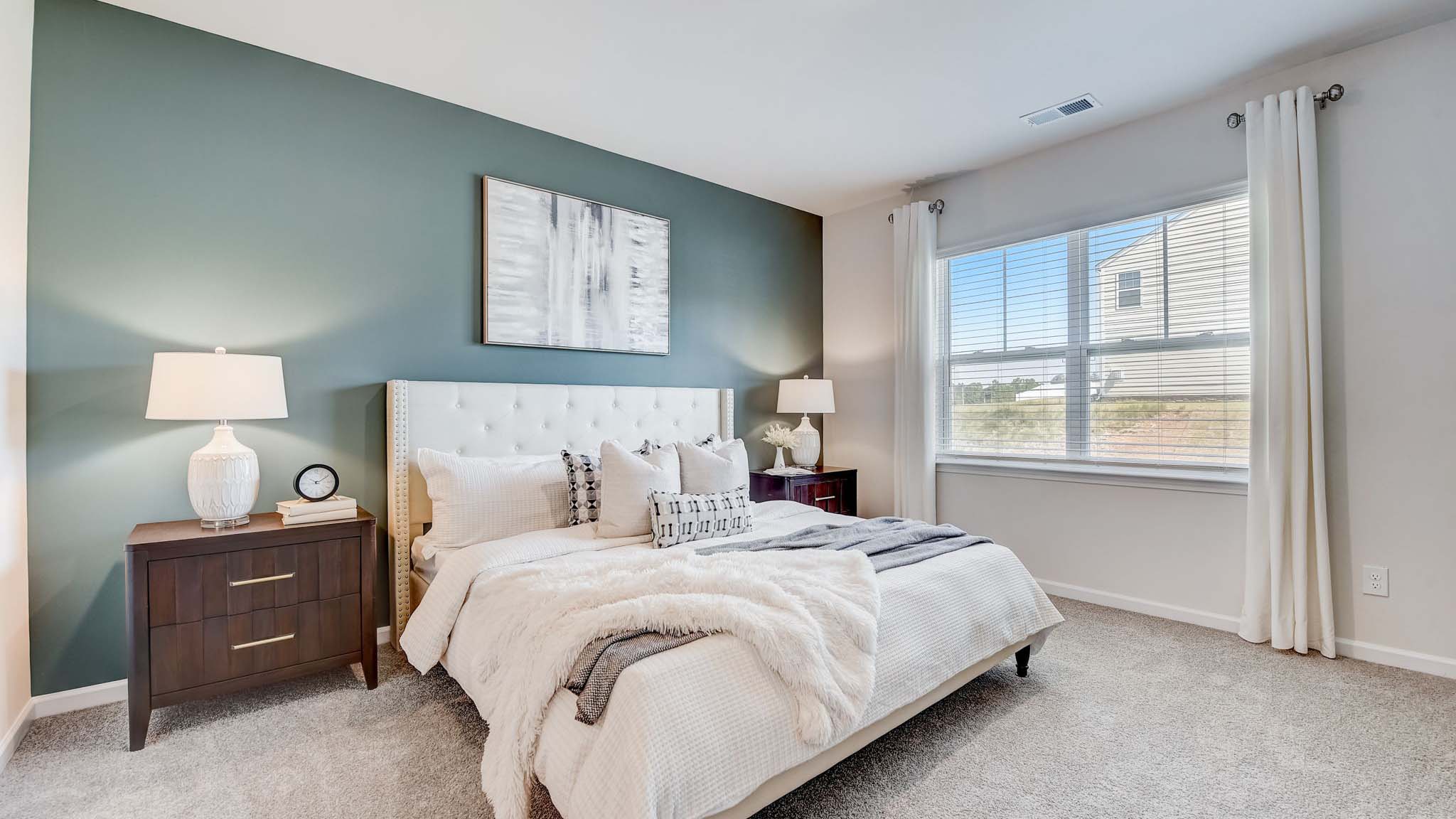Carpeted bedroom with large window