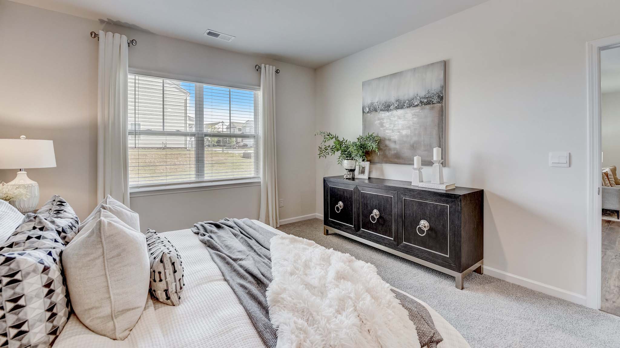 Carpeted bedroom with large window