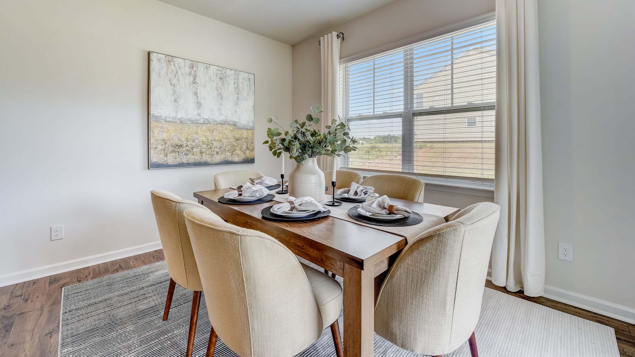 Dining room with wood floors, large window and sliding glass back door