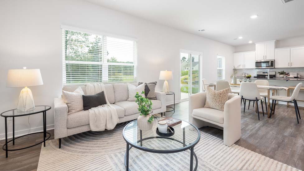 living room with vinyl flooring, electric fireplace and large window