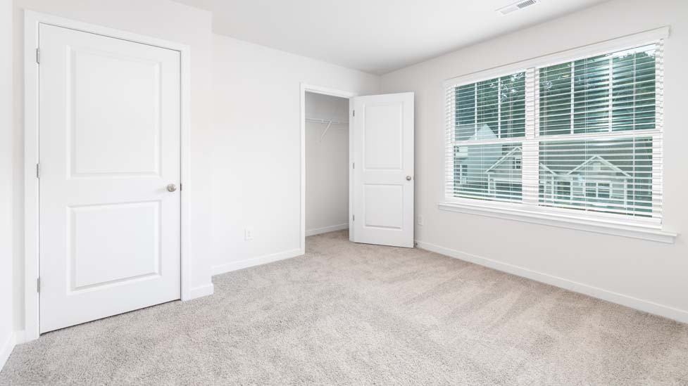 Carpeted bedroom with large window