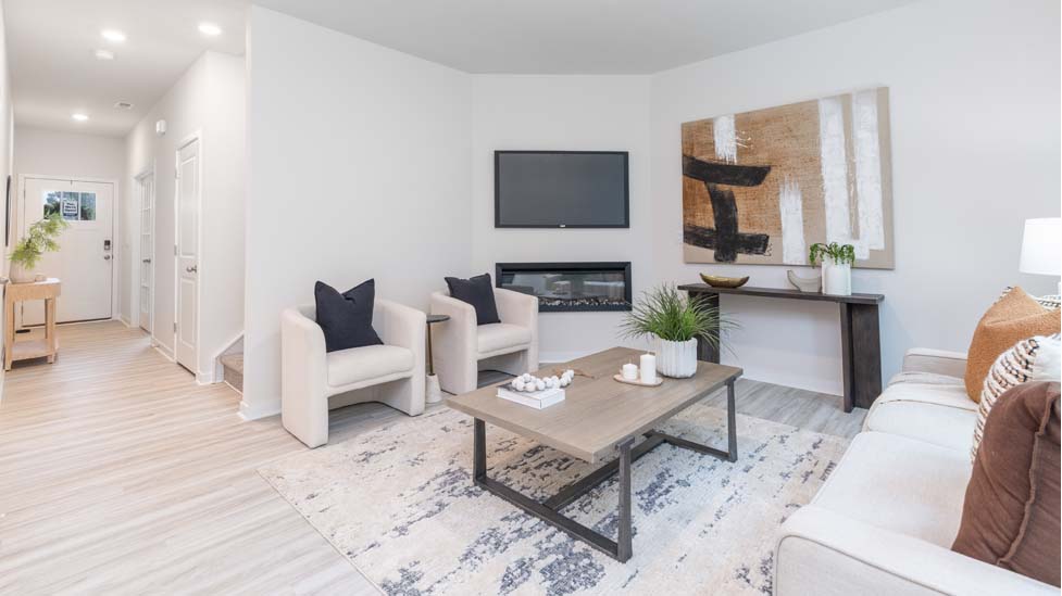 living room with vinyl flooring, electric fireplace and large window