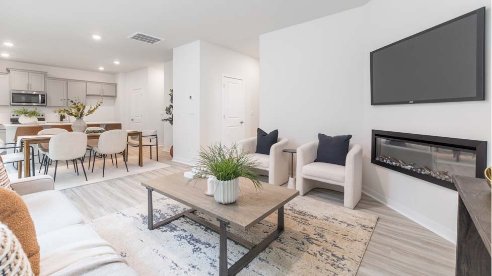 living room with vinyl flooring, electric fireplace and large window