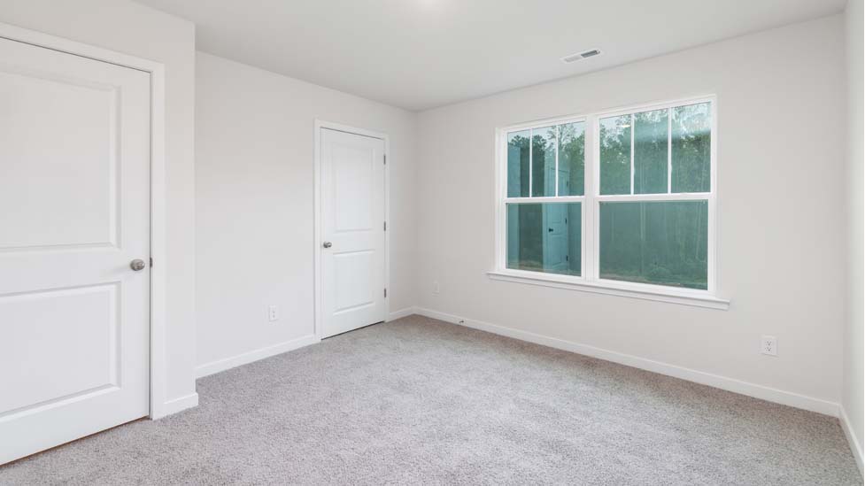 Carpeted bedroom with large window