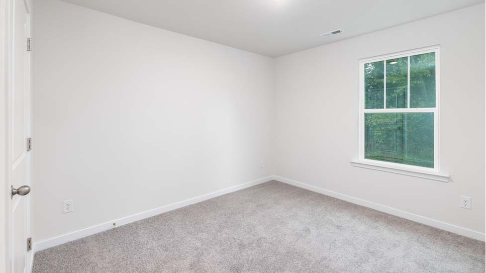 Carpeted bedroom with large window