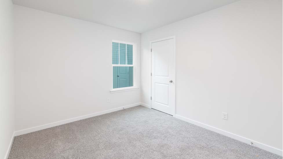 Carpeted bedroom with large window