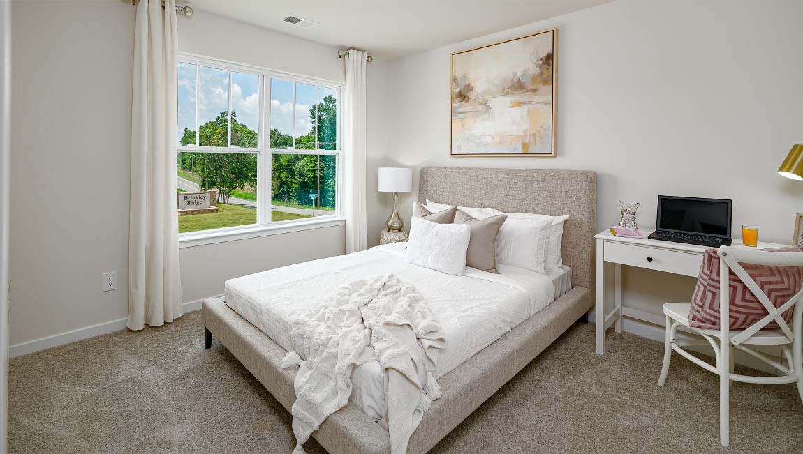 Carpeted bedroom with large window
