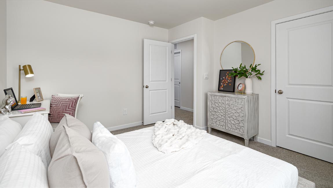 Carpeted bedroom with large window