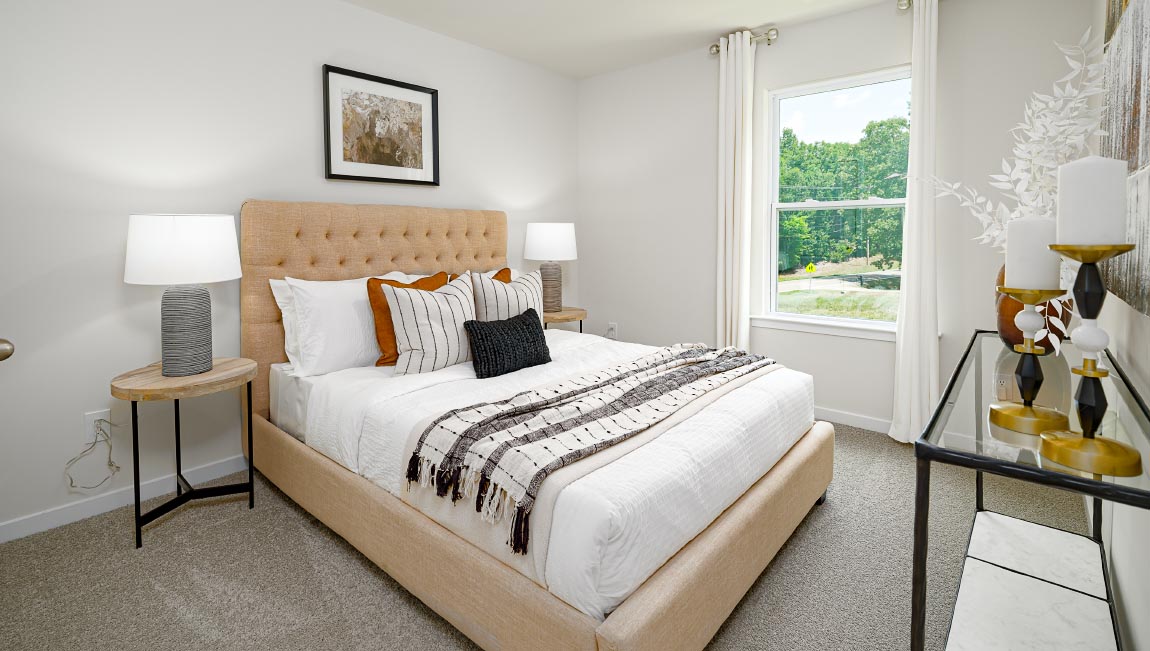Carpeted bedroom with large window