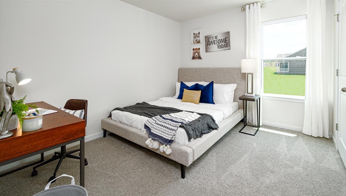 Carpeted bedroom with large window