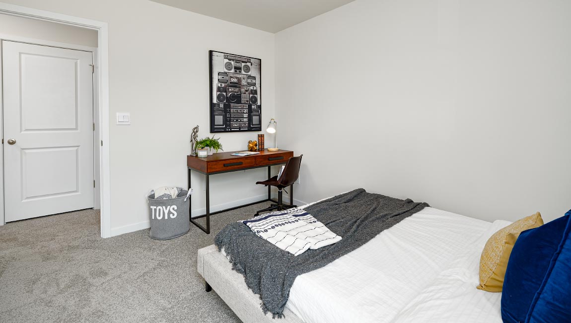 Carpeted bedroom with large window