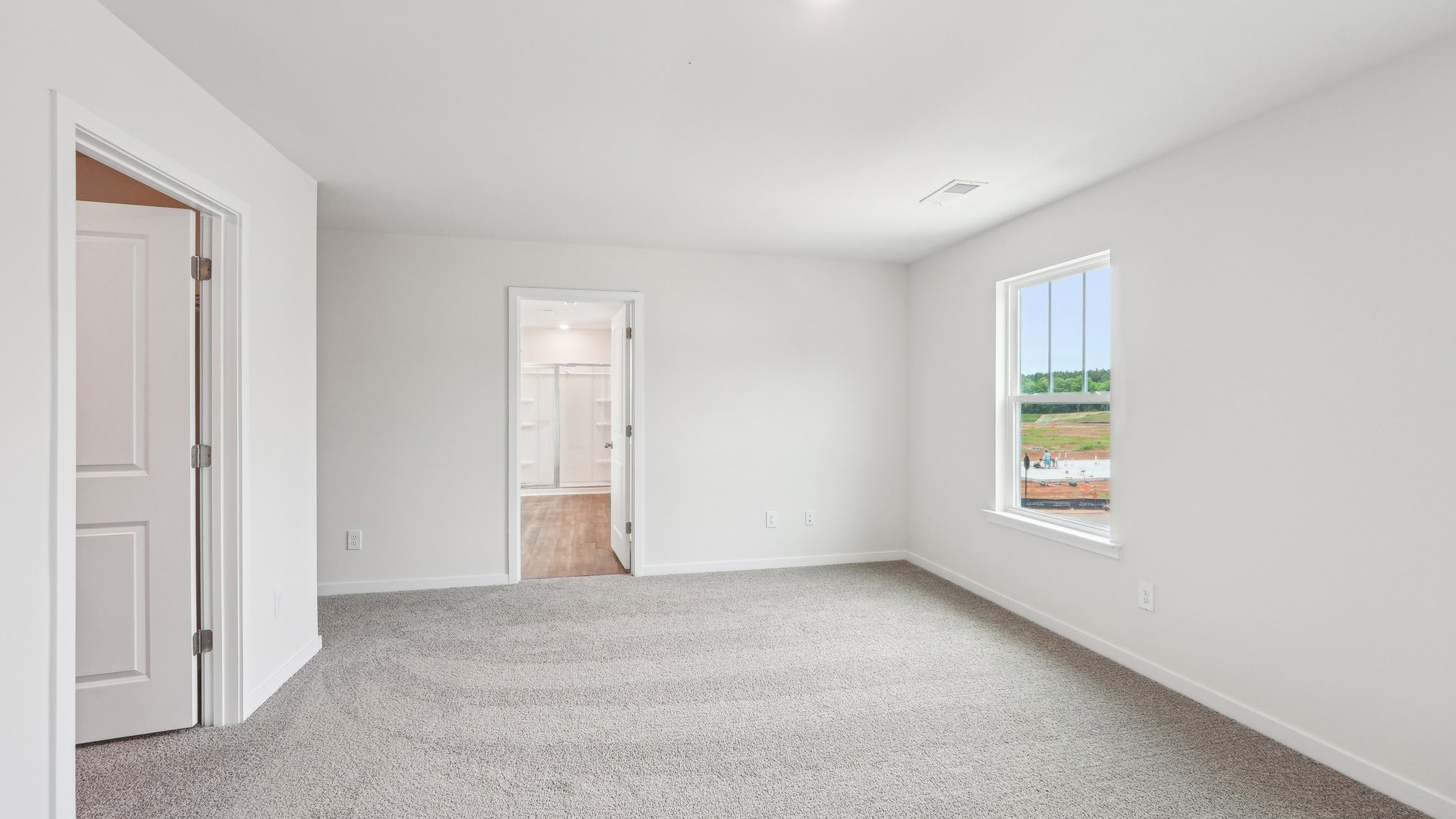 Carpeted primary bedroom