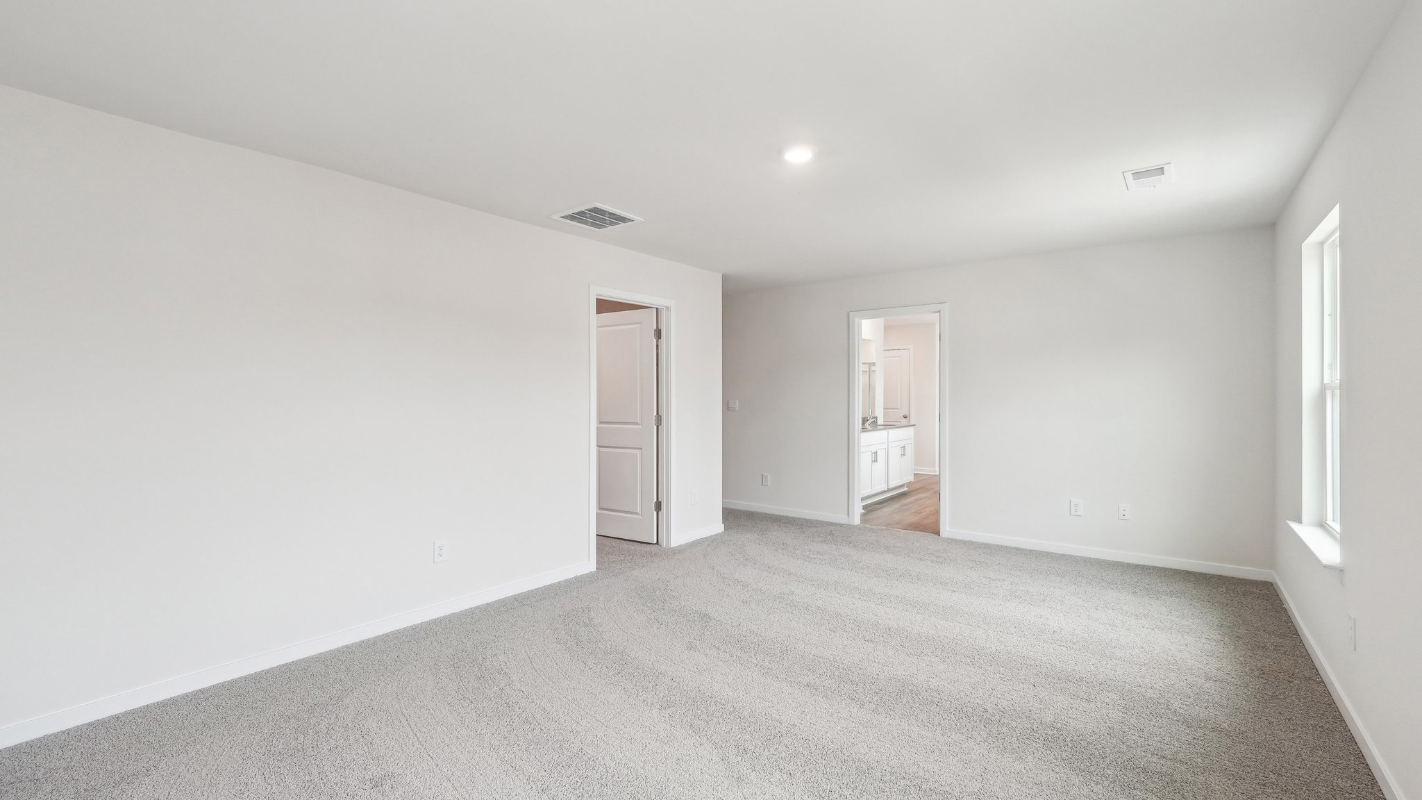 Carpeted primary bedroom