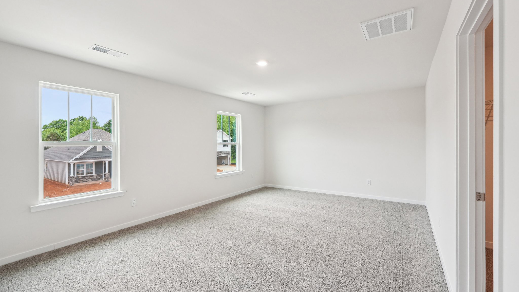 Carpeted primary bedroom