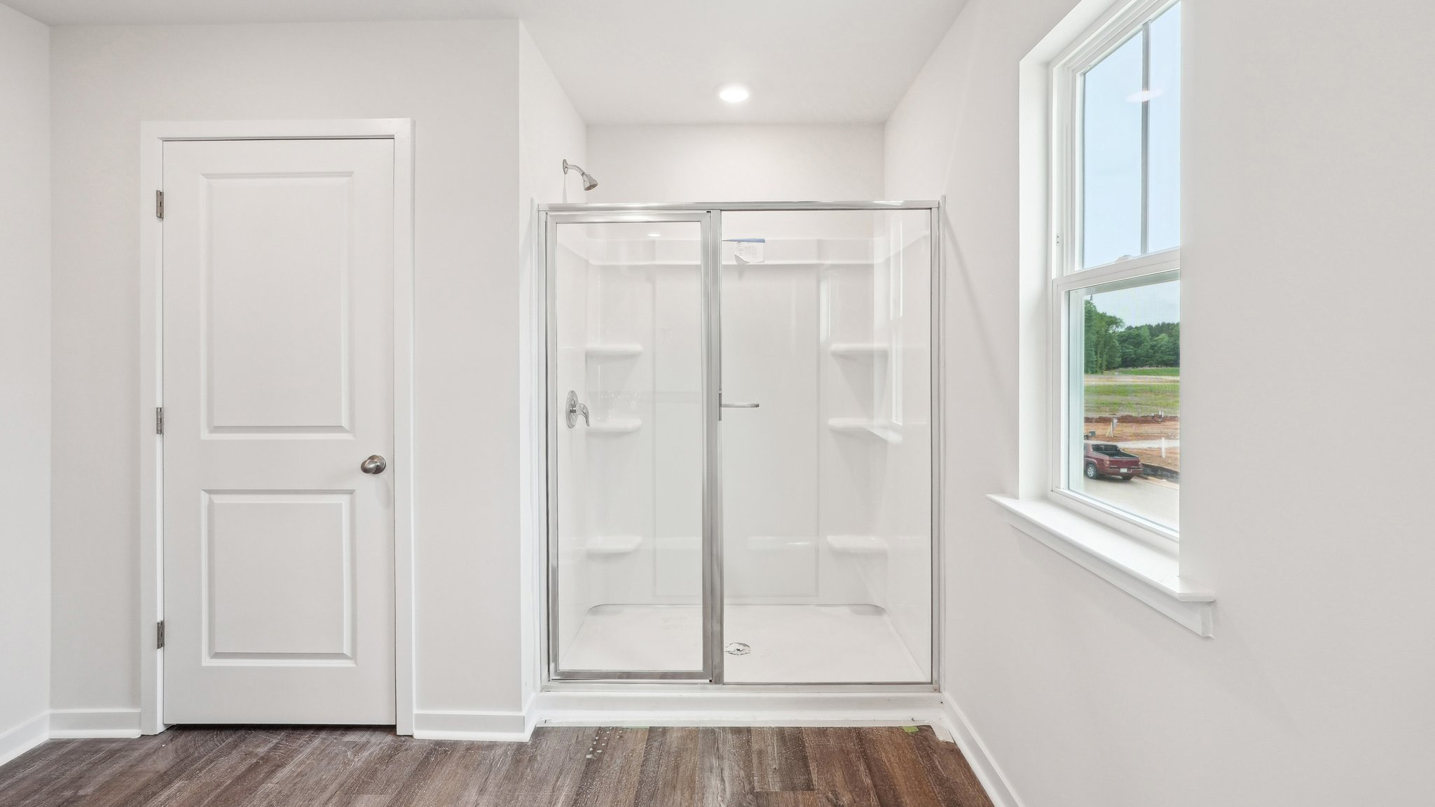 primary bathroom with standing shower and double sink vanity