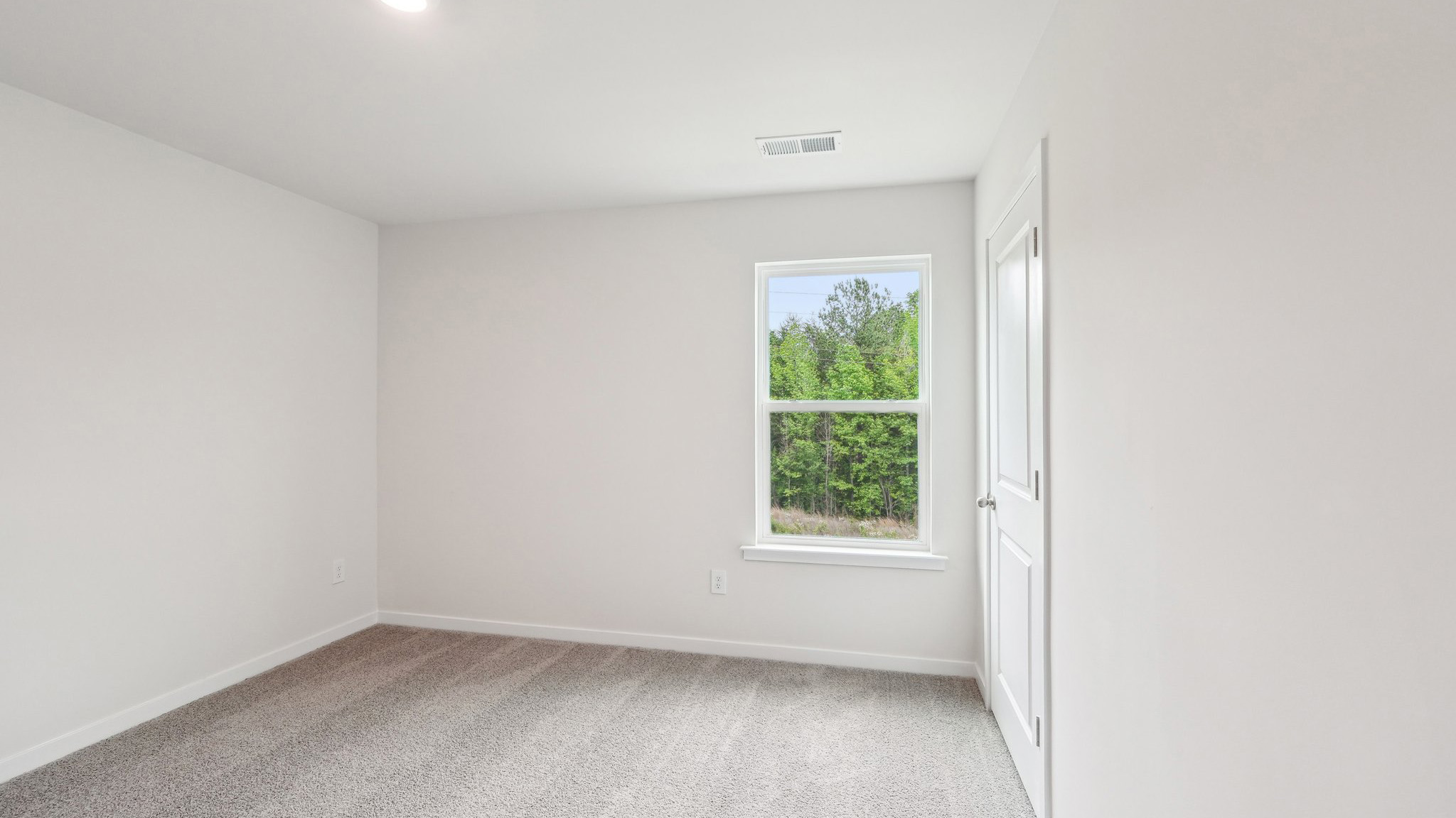 Carpeted bedroom with windows
